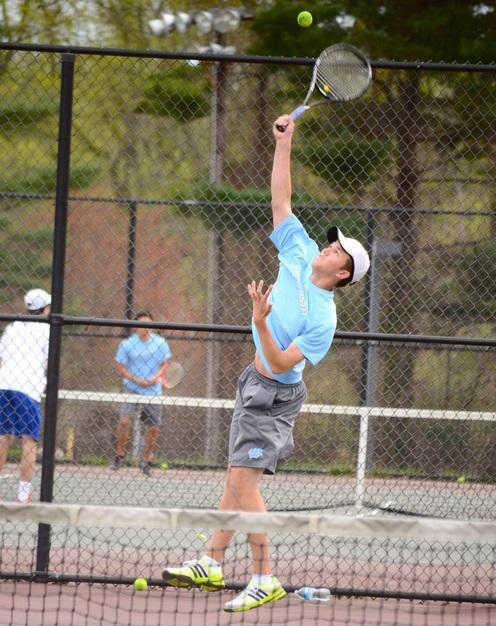 First singles player Jack Welch goes up for his serve. Despite the teams loss, he beat his opponent in two sets. Photo by Michelle Jarcho