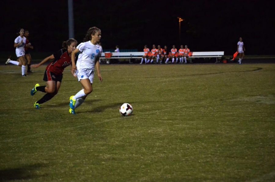 Midfielder Ellie Harris dribbles the ball up the wing before passing to forward Abby Meyers, who scored the second goal of six. Photo by Michelle Jarcho.