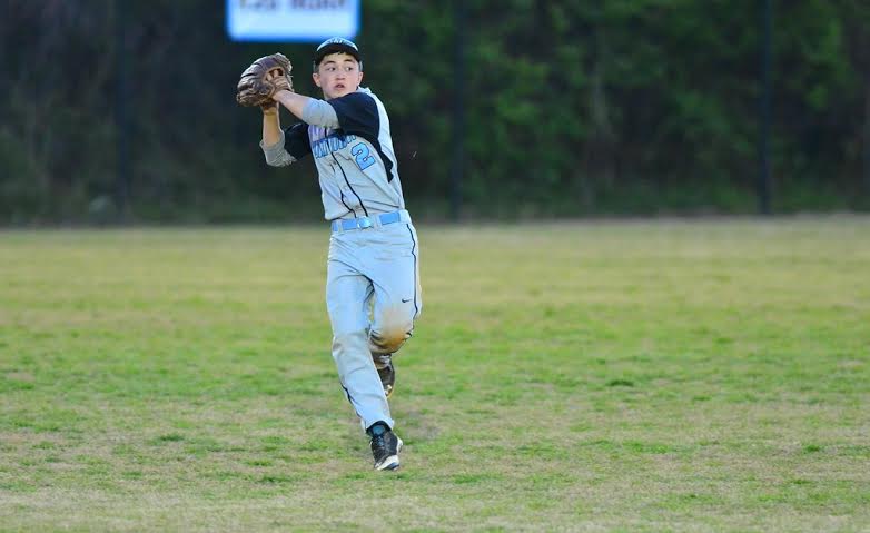 After catching a pop fly, outfielder Tyler Paul attempts to throw out a runner tagging up. The Vikes won on senior night over Northwood. Photo courtesy John Shiffman
