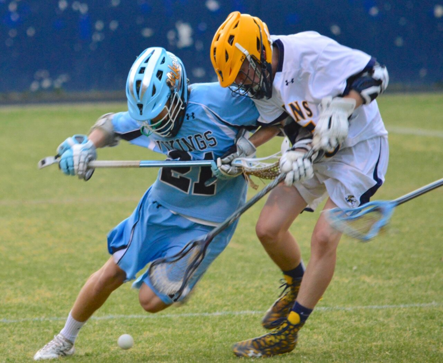 Midfielder Owen Roegge checks a defender in a physical contest against B-CC. Photo courtesy Keith Greenberg.