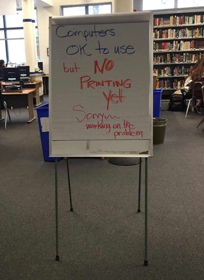 A sign in the library notifies students the printers were not working. Students were unable to print assignments on Monday because many of the printers in the school were down. Photo by Avery Muir. 