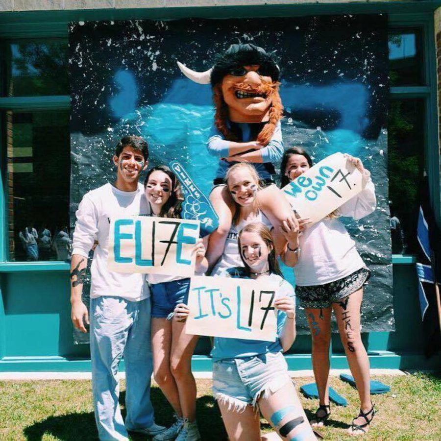 Rising seniors take pictures with the Whitman Viking, holding signs with class slogans like We own it. Photo courtesy Grace Goldman.