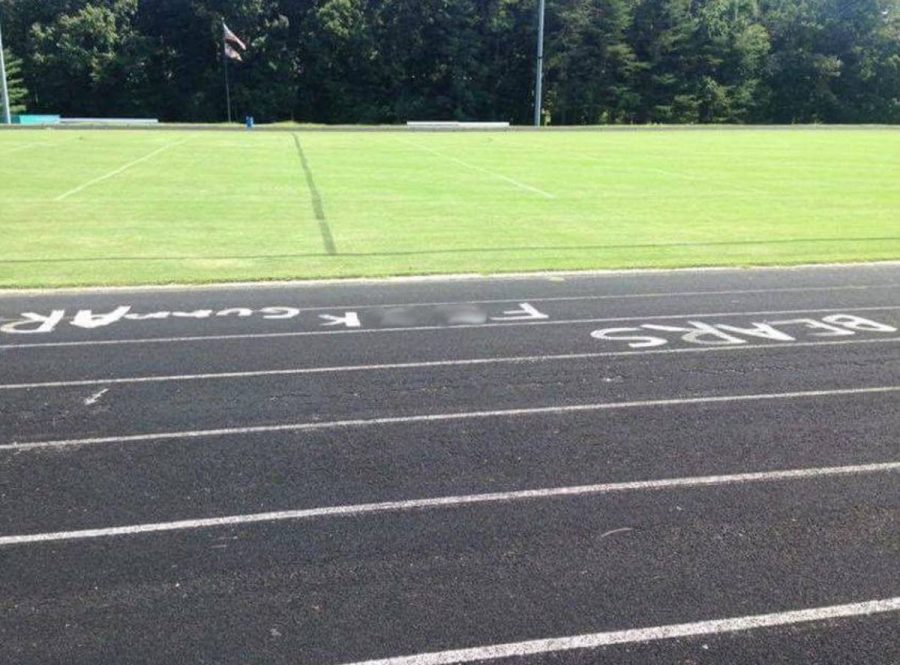 Whitman track and nearby street sign vandalized