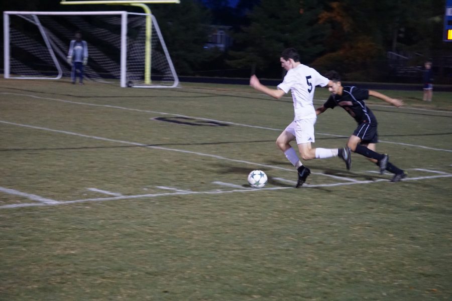 Defenseman Kevin Kaufman looks to cross the ball over the middle of the field in the team's 3–0 victory over Northwood. Photo by Lauren Gates.