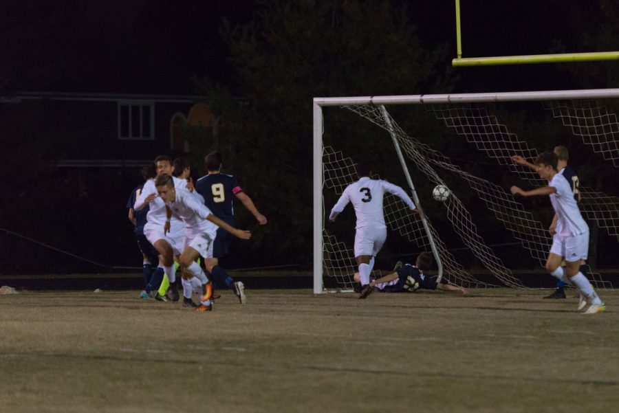 Forward Andreas Djurhuus heads in one of his two goals in the first half against B-CC. Photo by Jefferson Luo.