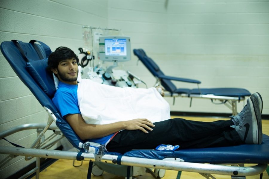 Senior Ferzam Mohammad gets ready to have his blood drawn in the years first blood drive. Photo by Tomas Castro.
