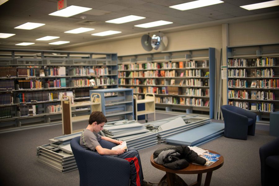 Emptied bookshelves are broken down to make room for more open study space in the media center. Photo by Tomas Castro.