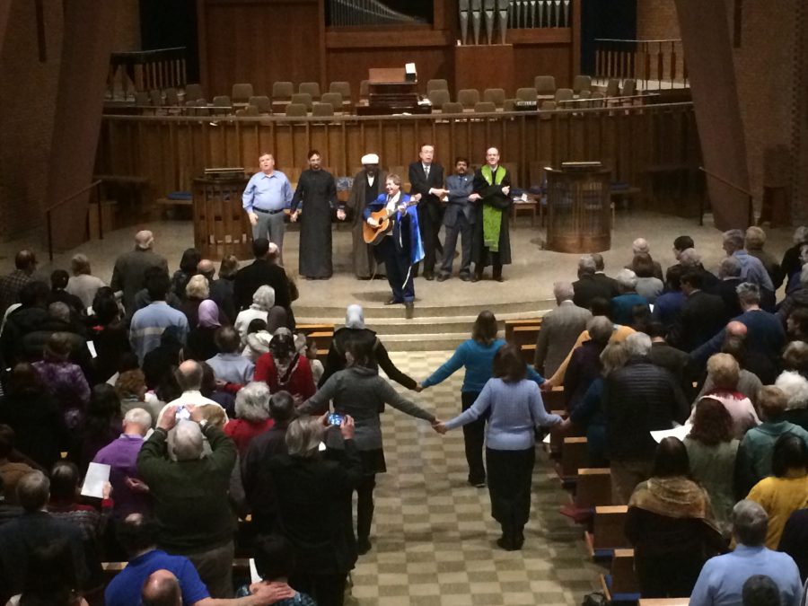 After a series of prayers Feb. 9, worshippers joined hands and sang “We Shall Overcome,” the final anthem of the service held in the shared sanctuary of BHPC and BJC. Photo by Camille Caldera.