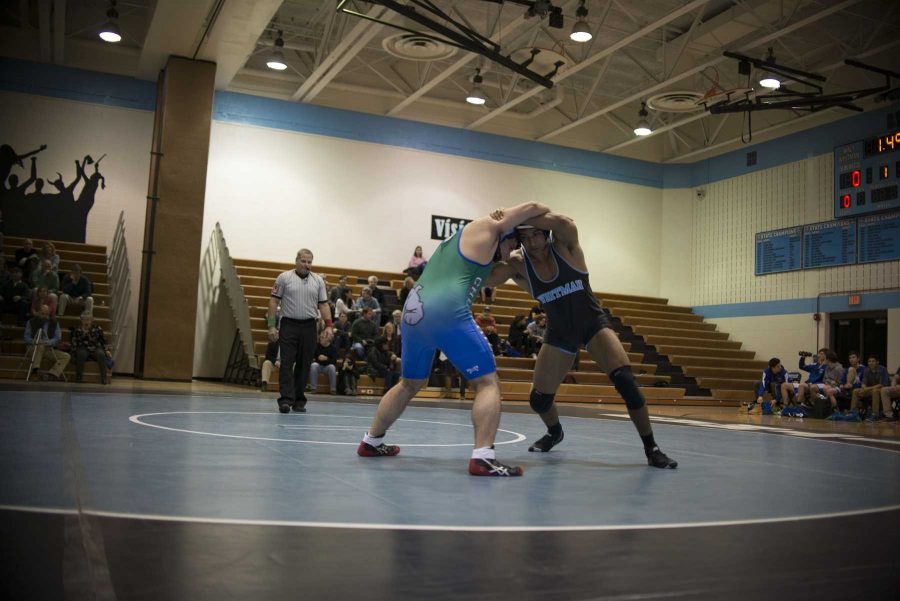 Junior John Luke Iglesias goes head to head with a Churchill opponent in a match on January 27th. Photo by Annabelle Gordon. 