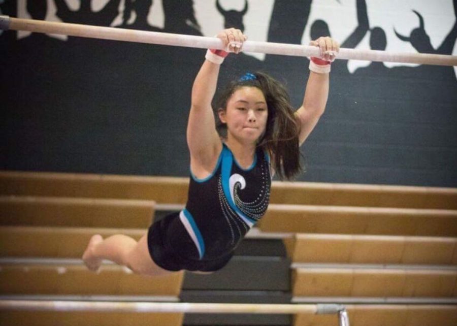 Senior captain Annie Burton practices her technique and choreography on her bar routine. The Vikes took third place at the county championship on May 9. 
Photo courtesy Annie Burton.