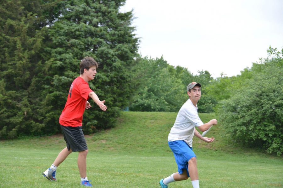 Senior Josh Strauss (right) prepares to launch the Frisbee down field to a teammate. Strauss, the team captain, played a big part in the teams successful season. Photo by Anna Gray. 
