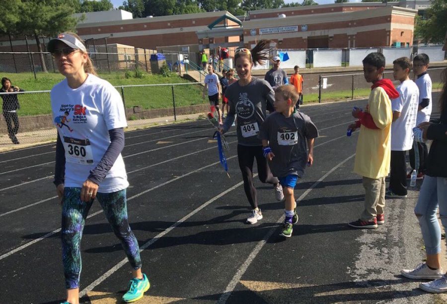 With his mom running by his side the last few feet of the race, elementary schooler Luka Kreicheling finished first in Hope for Henrys annual 1 Mile Fun Run. Photo by Jessie Solomon. 