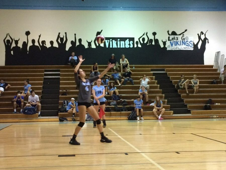 Outside hitter Olivia Personeni serves the ball against the Wheaton Knights in the second set. Personenis kills helped lead the team to the second set victory. 
Photo courtesy of Colby Fong