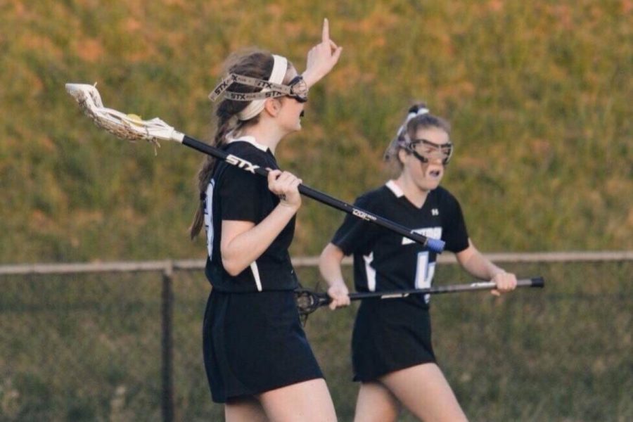 Sophomore Maya Svec and senior Gaby Svec take the field together in lacrosse. The sisters, one of the many pairs of siblings who play on sports teams together, cite team bonding and high standards as benefits of playing with siblings. Photo courtesy Gaby Svec. 