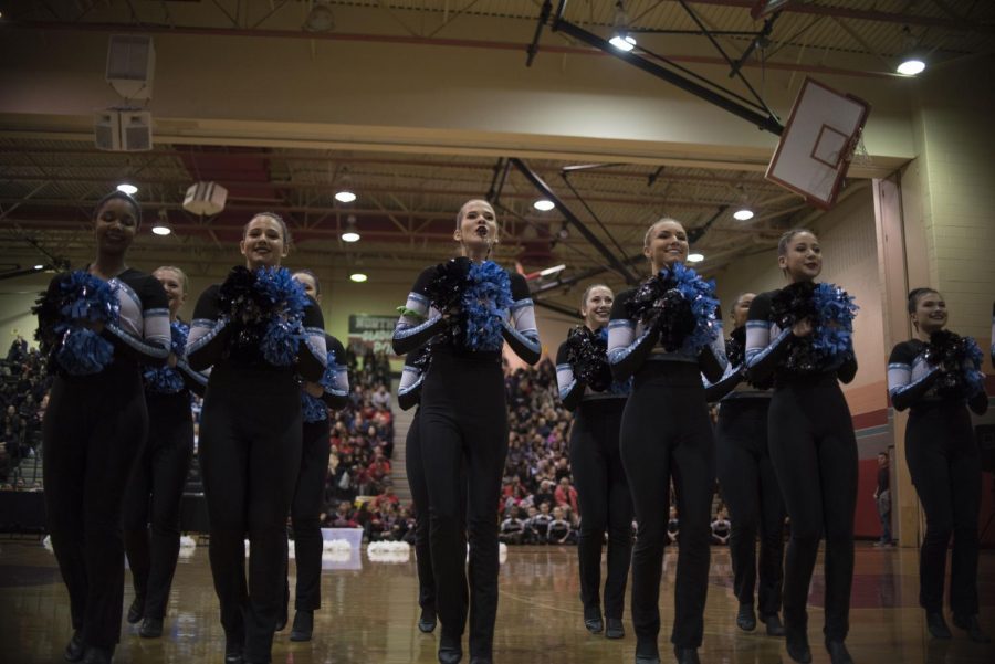 Senior Sofia Luzuriaga blows a whistle as the team marches onto the court. The Poms were confident in their routine and placed second on Saturday, February 3rd for division two county championships.  Photo by Annabelle Gordon