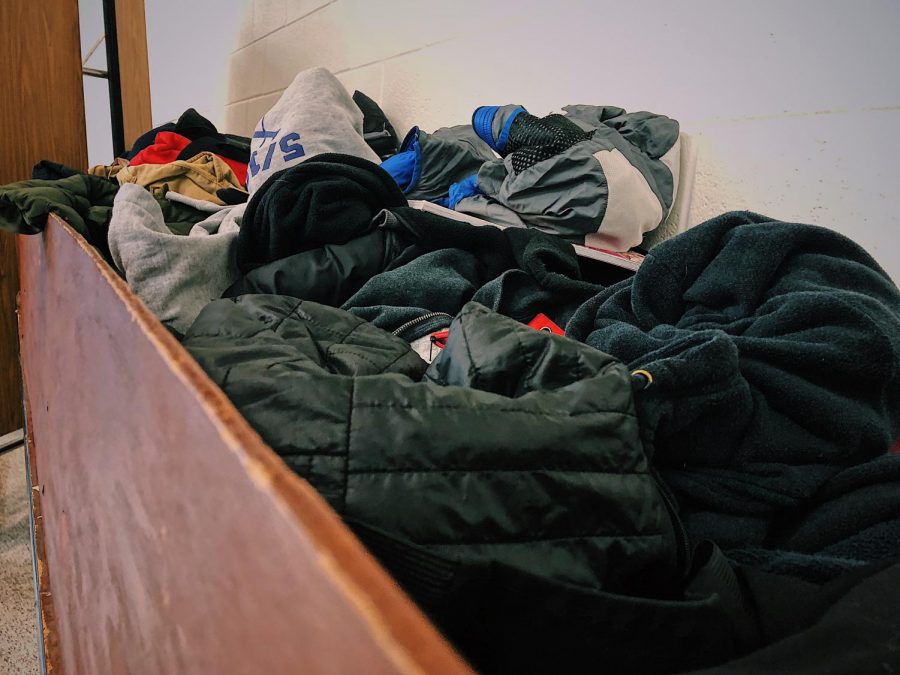 Items lay strewn in Whitmans lost and found. To organize items and serve the lost and founds purpose, building service and students should organize the bins by item. Photo by Olivia Matthews. 