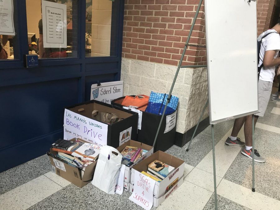 Boxes of donated books sit in the front hall by the main office. Whitmaniacs dedicated this years book drive to Dr. Goodwin, in honor of his nineteen years at Whitman. Photo by Sydney Miller. 
