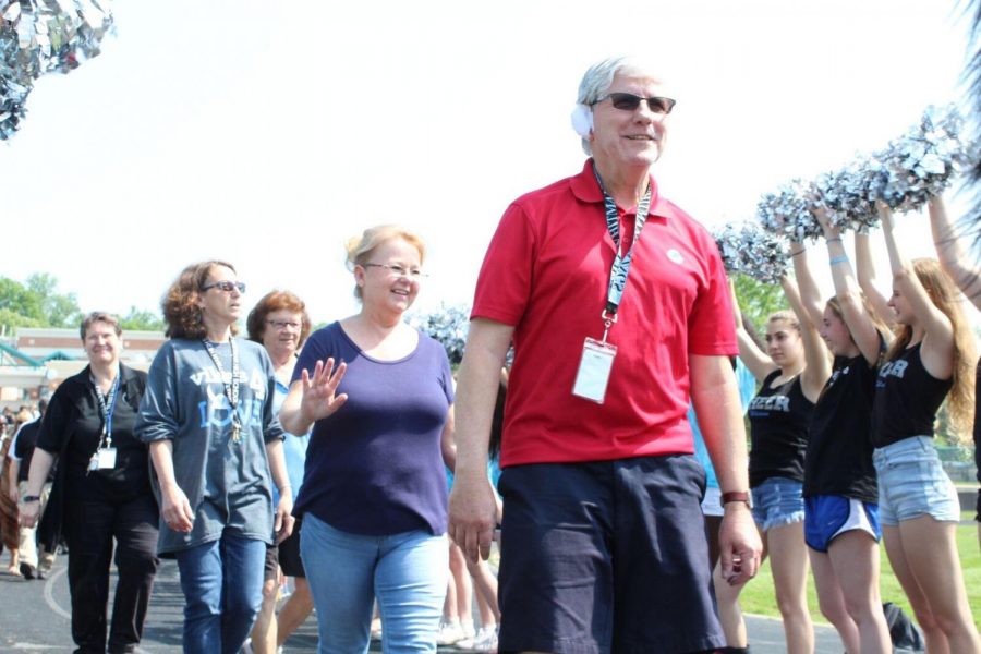Karen Phillips (Left Center) and Robert Dyer (right) smile as they walk. Phillips has managed the cafeteria for 11 years and Dyer has been a paraeducator for the last 6 years at Whitman. Photo by Annabel Redisch.