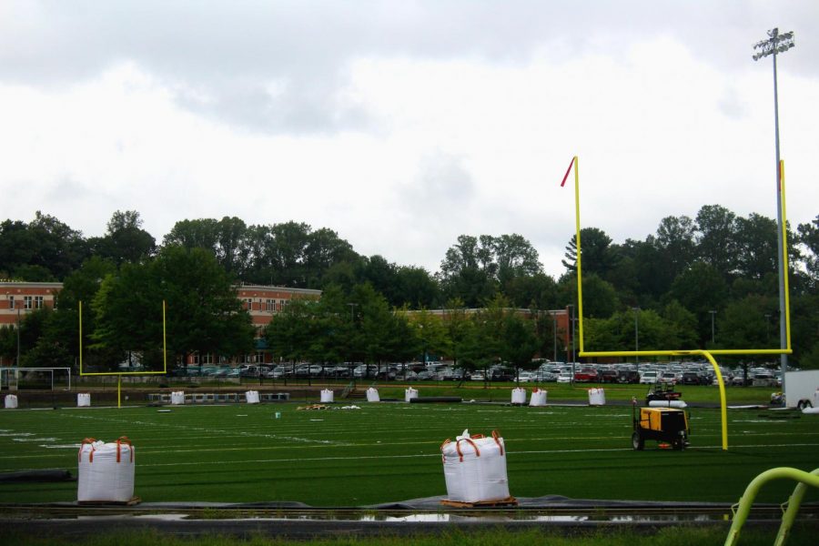 Construction on the turf field pauses for the day due to rain. After four months of work, the field remains unready for use.