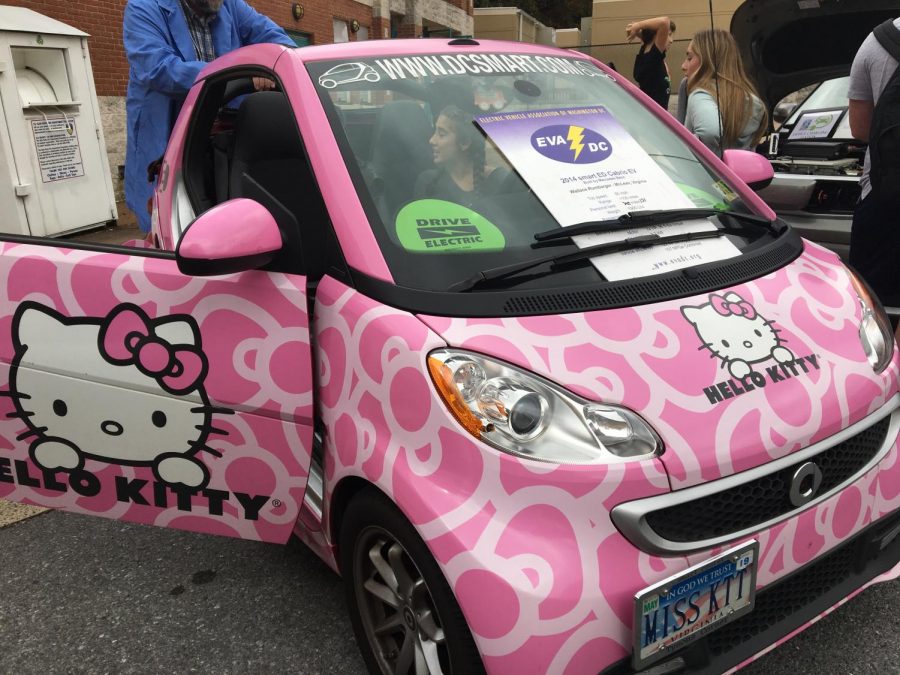 A student sits in EVADC member Wallace Rumbargers electric car. Rumbarger originally bought the Hello Kitty design for marketing, but now he likes the decor  because it makes people smile.
