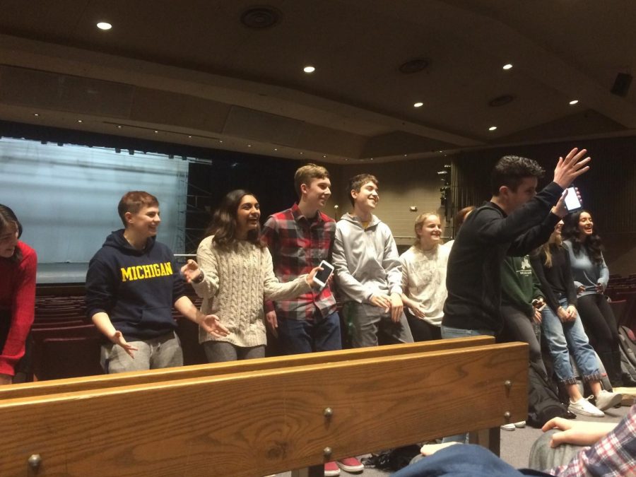 Senior Davis Gestiehr and the student directors of the talent show shout the theme of this years show: Uprising. The theme was revealed at an information meeting Nov. 27.