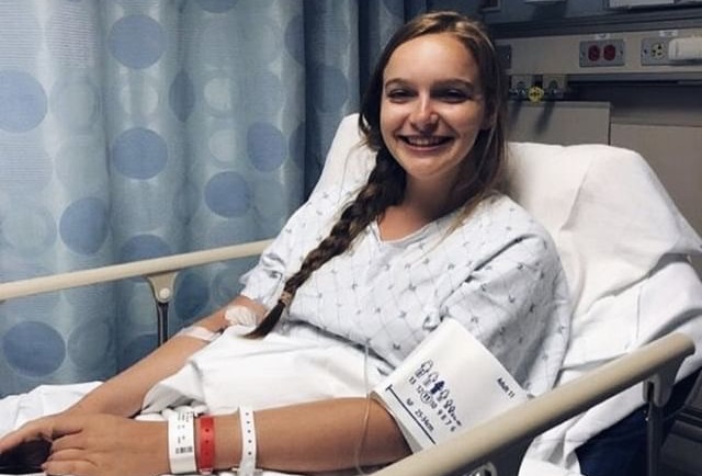 Junior Caroline Muir smiles before an endosscopy and a liver biopsy at Georgetown University Hospital this summer. Muir has POTS, and has had several procedures to manage her symptoms. 