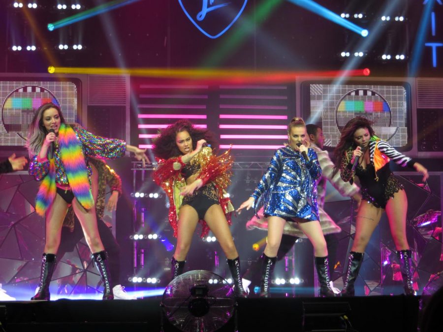 Little Mix performs on stage. Although the group's latest album has an empowering message, the songs' lyrics feel cliche.  