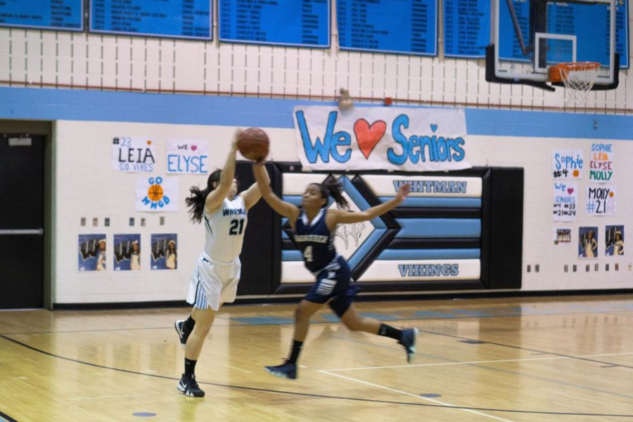 Senior Molly Knox reaches for the ball. Whitman played Magruder on senior night, an annual tradition to honor an end to four years on Whitman basketball. 