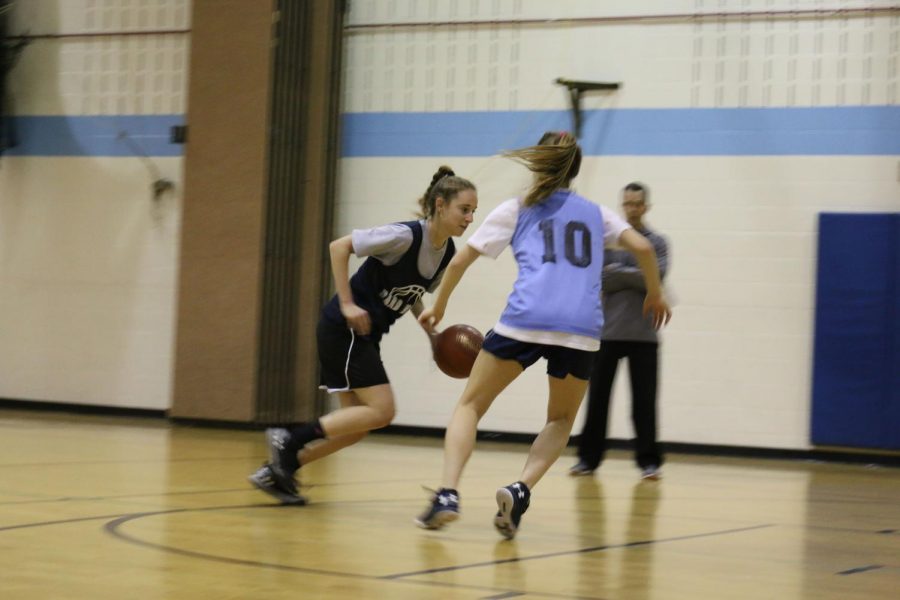 Guard Jaclyn Morgan takes the ball to the hoop against guard Lexi Fleck. Morgan and Fleck are the two sophomores on the varsity team. 