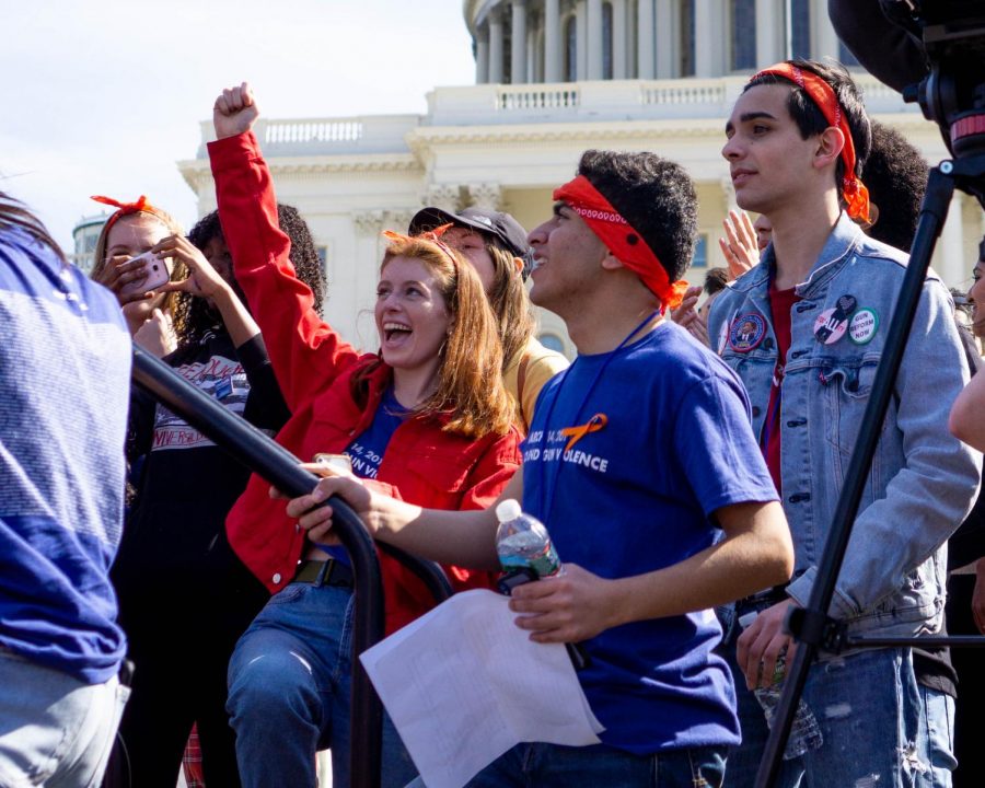 B-CC student Emily Schrader pumps her fist in the air. Schrader is part of the Moco Students for Change leadership board; she made t-shirts for the walkout and gave a speech at the Capitol.