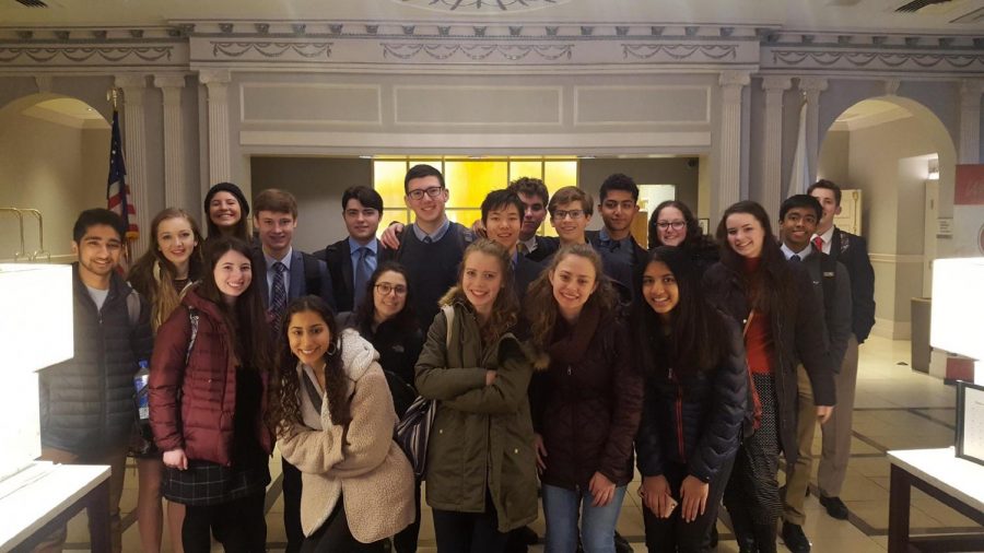 The public forum team poses for a picture at the hotel before going to rounds. The Harvard Tournament is traditionally freshmens first exposure to traveling with the team. Photo courtesy Ethan Singer.  