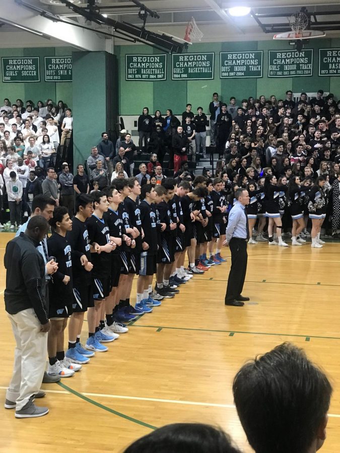 The boys basketball team lines up for the national anthem before the teams playoff loss against the Walter Johnson Wildcats. The team ended their season in a heartbreaking overtime loss, but the players are proud of what they accomplished this season. Photo courtesy Blake Layman. 