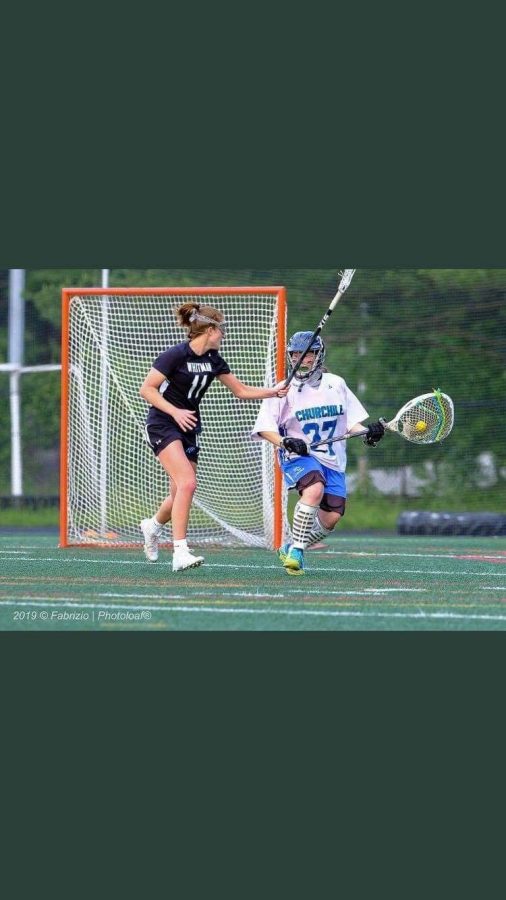 Attacker Abby Waldvogel plays close defense against the Churchill goalie in the Vikes 12–11 win against the Churchill Bulldogs in the third round of the playoffs. Photo courtesy of Phil Fabrazio. 