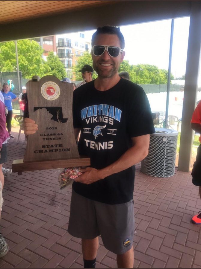Boys tennis coach Jasen Gohn poses with the boys and girls state tennis trophy. Photo courtesy of Jeff Sullivan Twitter. 
