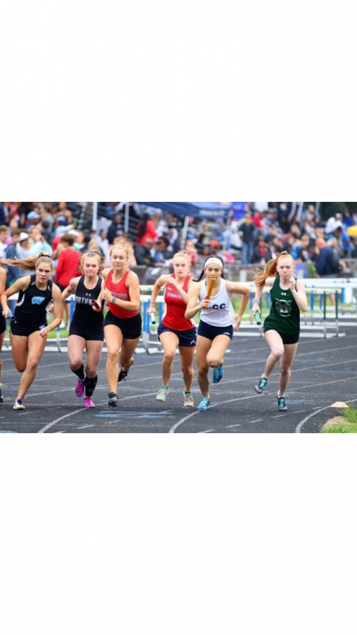 Junior Isabella Bravo (far left) competes in the relay event at the MCPS Track and Field County Championships. Photo courtesy of Elizabeth Sklaire. 