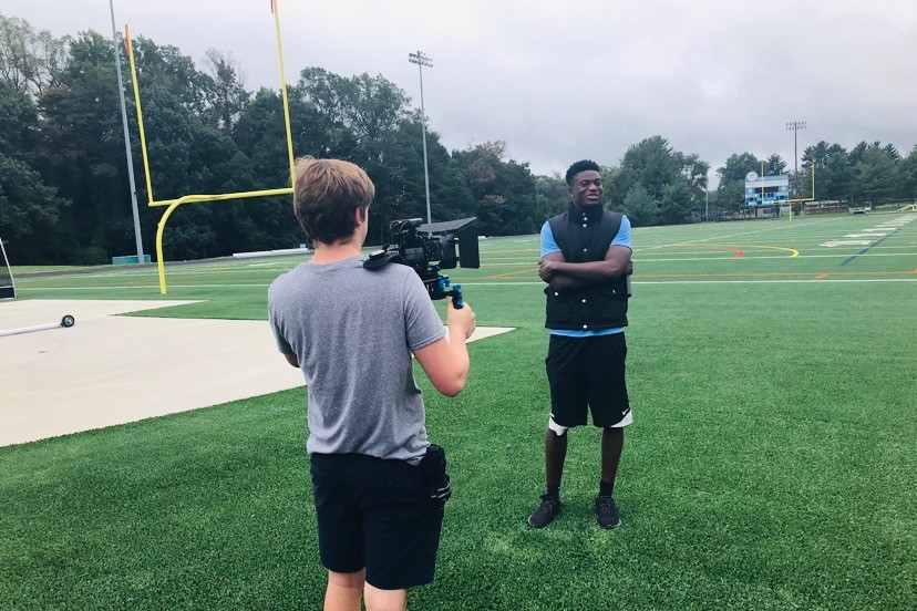 Junior Nick Cook films senior Philip Diby for a Whitman Shorts segment. Administrators cut Speaks and Briefs, two popular segments, from Shorts for the 2019-2020 school year because of their lack of journalistic elements. Photo courtesy Tina Xia.