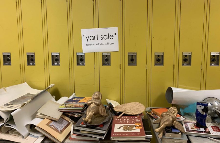 Books and artifacts clutter a table outside D309. Art teacher Nancy Mornini left out the supplies for students to take at her yart sale. Photo by David Villani.
