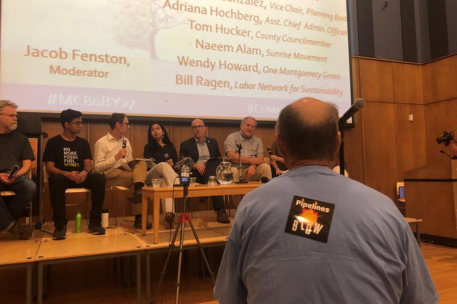 Activist Walter Weiss faces a panel of county officials and local activist. His sticker—“pipelines blow”—advocates for the banning of fracking pipelines.