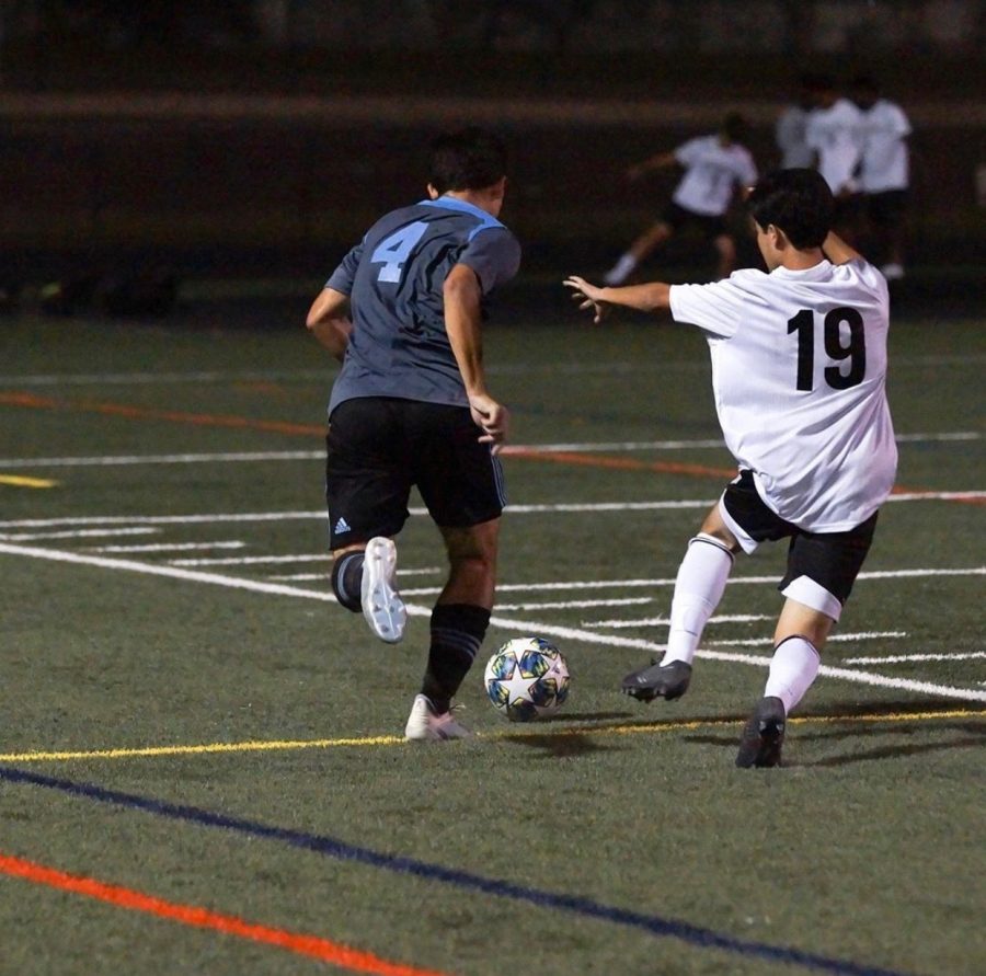 Centre-back Hunter Lee dribbles past a defender in the Vikes 5–0 win over the Wheaton Knights. Photo courtesy of the Whitman Mens Varsity Soccer Instagram.  