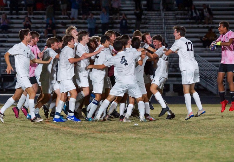 The boys soccer team celebrates after their 2–1 overtime win over the Northwest Jaguars. Photo courtesy of Sos Mboijana