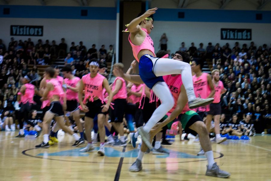 The Guy Poms perform in the main gym at last years homecoming pep rally. This year, they will perform on the field because the event has been moved to the stadium.