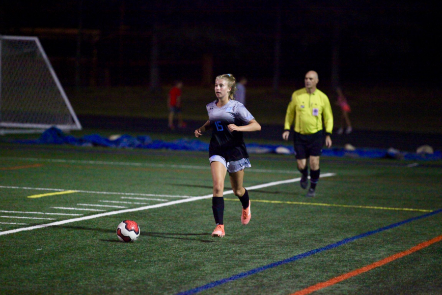 Defender Lexi Fleck dribbles the ball up the field in the girls soccer teams  5–1 win against the Einstein Titans. Photo courtesy of Bill James.