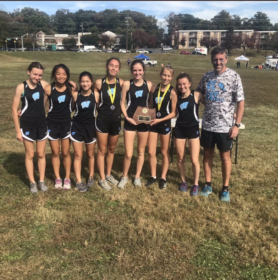 The girls varsity cross country team poses with the first place trophy in the county championships. Photo courtesy of the MCPS Athletics Twitter. 