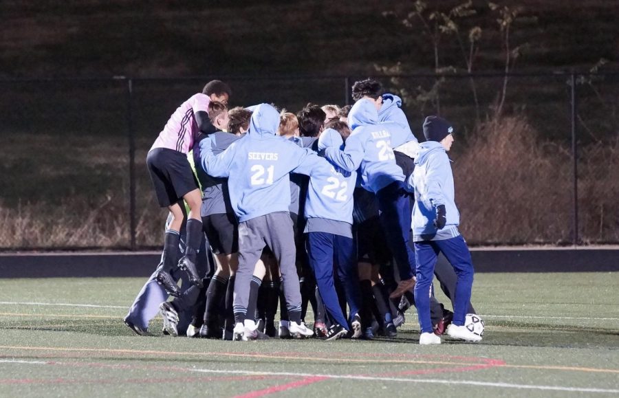 The boys soccer team celebrates their 4–3 overtime win over Wootton in the state semifinals.  Photo courtesy of Sos Mboijana.