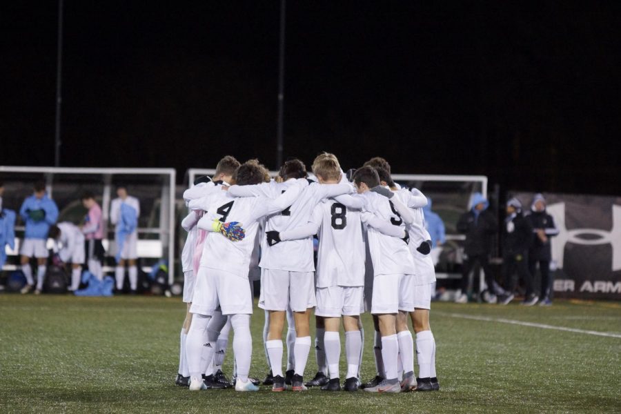 The boys soccer team huddles together before start of the state final game. 