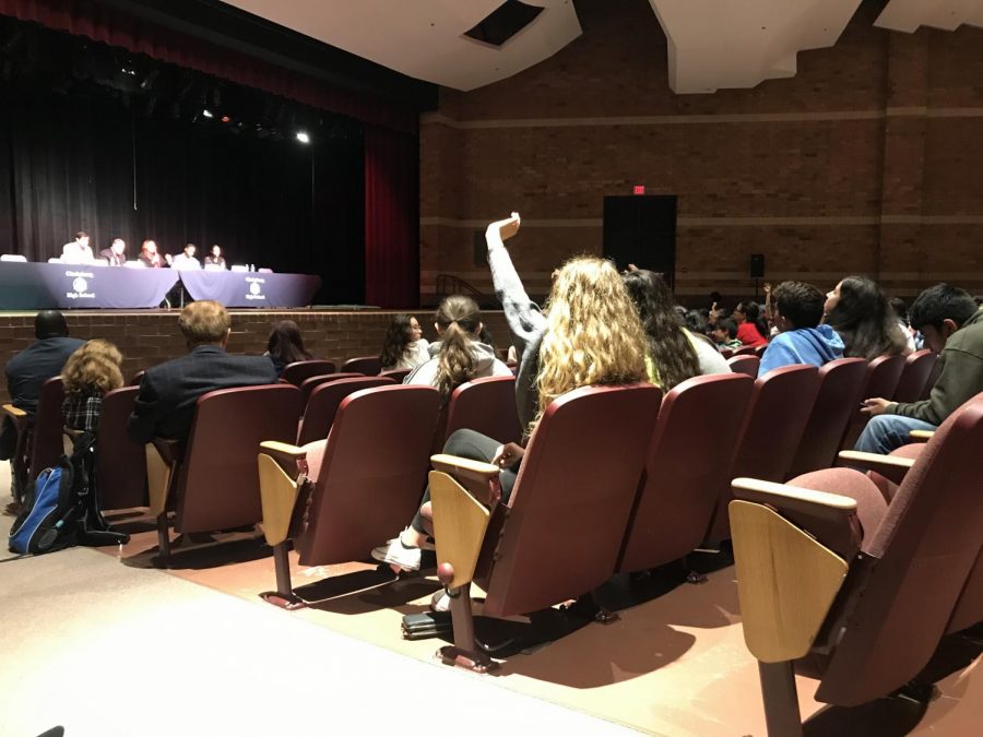 Clarksburg Junior Charlotte Sanford raises her hand to ask the panel a question. She, like many other students at the town hall, asked about how the boundary study would affect her school.