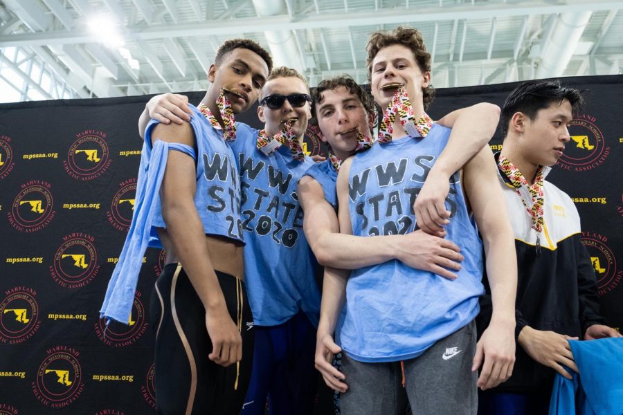 The boys 200-yard freestyle relay stands on the podium at the State Championship. The relay won All-Met 200-yard Freestyle Relay of the Year.