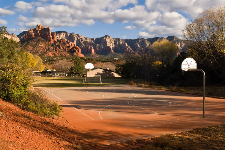 A public school playground in Sedona, Arizona. This photo is a part of a series called Hoops by Bill Bamberger.