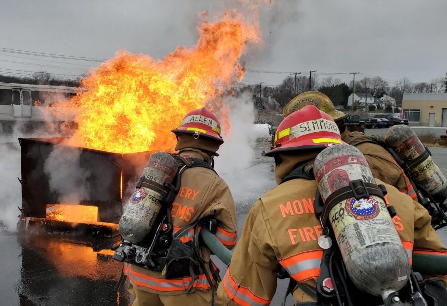 Cadets at the Montgomery County Fire Rescue Service Training Academy practice setting out a fire on a car during a burn, which lasts a full day. 