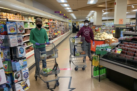 Teens Helping Seniors founders Matthew Casertano and Dhruv Pai shop for groceries before delivering them to senior citizens.